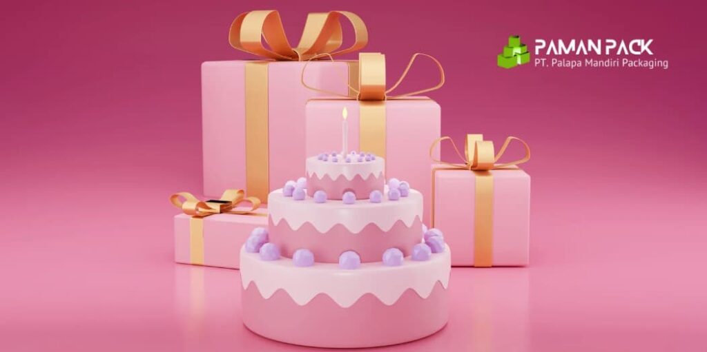 kue ulang tahun dengan box dibelakang warna pink